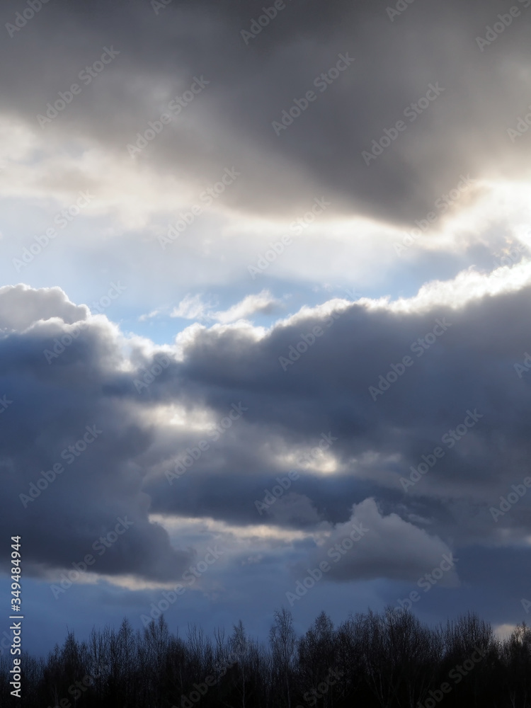 Dark and white clouds on a background of blue sky Dark and white clouds on a background of blue sky