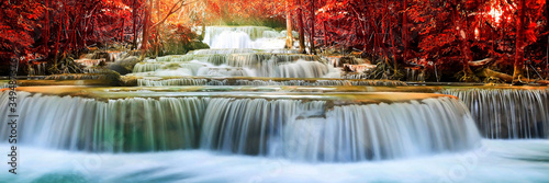 Beauty in nature  beautiful waterfall flowing of water with turquoise color of water in colorful autumn forest at fall season