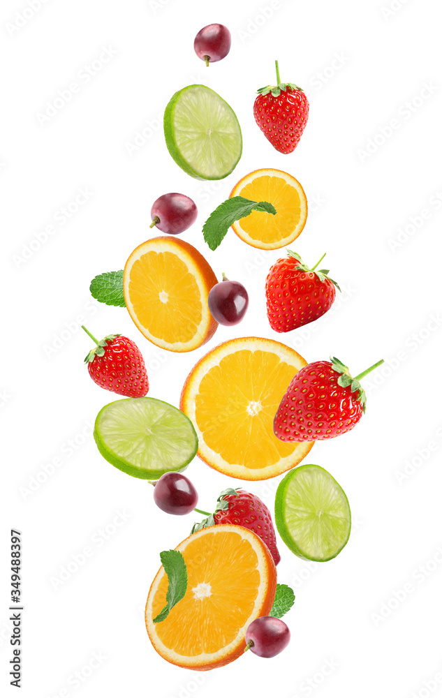 Naklejka premium Set of different cut fresh fruits and berries falling on white background