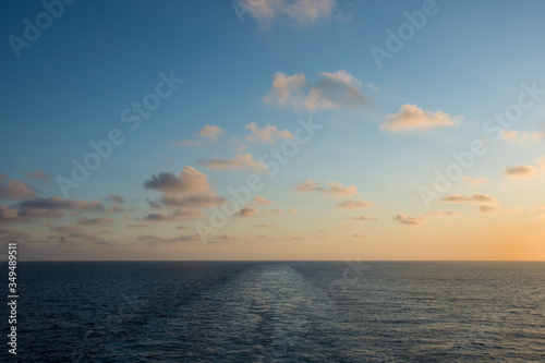 Sunset on the sea with wake of the ship