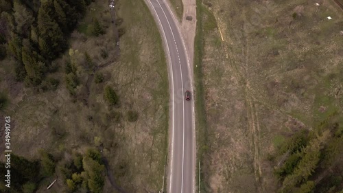  the car goes on a mountain road, shooting from a height
