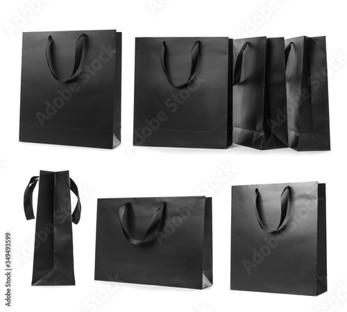 Set with black paper shopping bags on white background