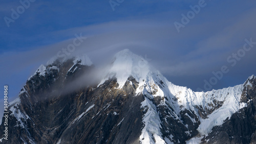 clouds circulating around a mountain peak which gives a cold sensation
