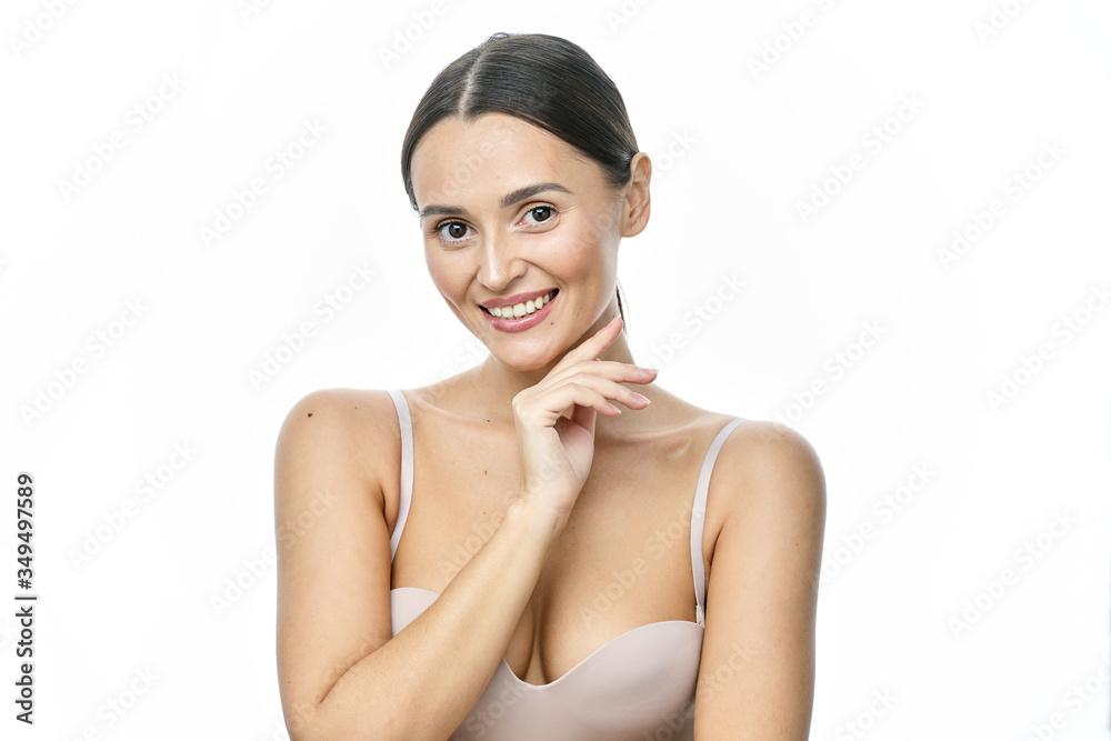 Close up portrait of a girl with big eyes and clear skin on a white background with a beautiful wide smile and white teeth Close up portrait of a girl with big eyes and clear skin on a white background with a beautiful wide smile and white teeth
