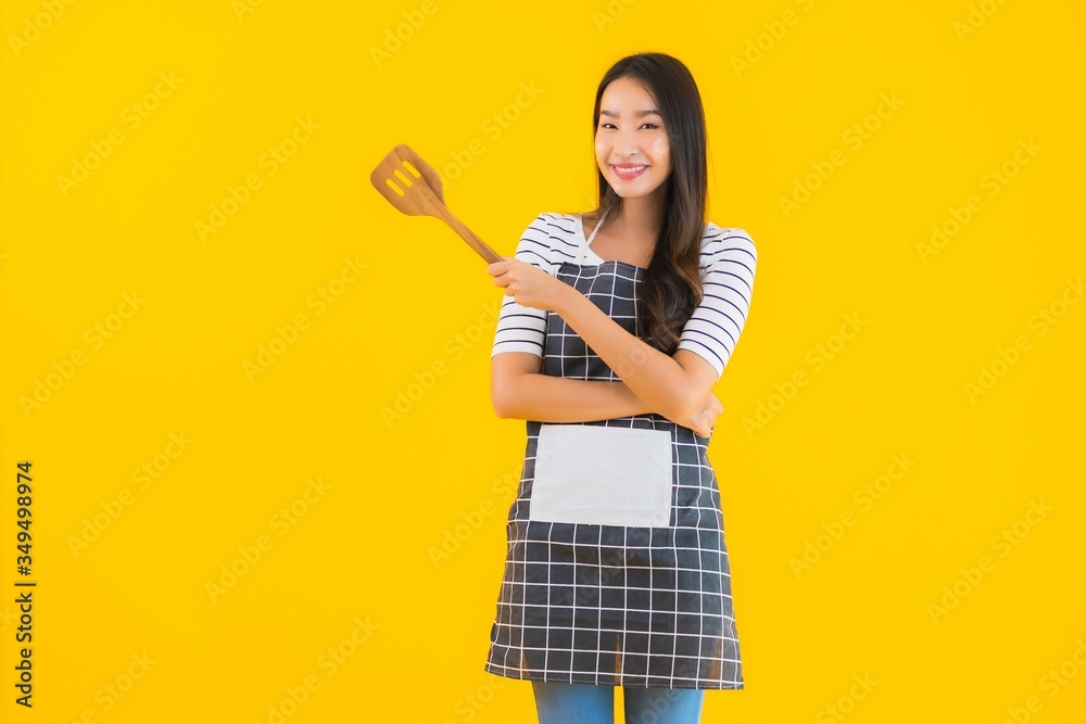 Portrait beautiful young asian woman wear apron with black pan and Spatula Portrait beautiful young asian woman wear apron with black pan and Spatula