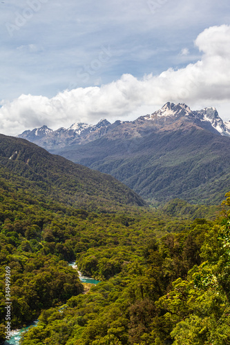 Fiordland National Park. Landscapes of the South Island. View of the snow-capped mountains, dense forest and the river below. New Zealand