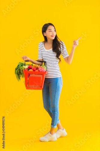 Portrait beautiful young asian woman with grocery basket cart from supermarket in shopping mall