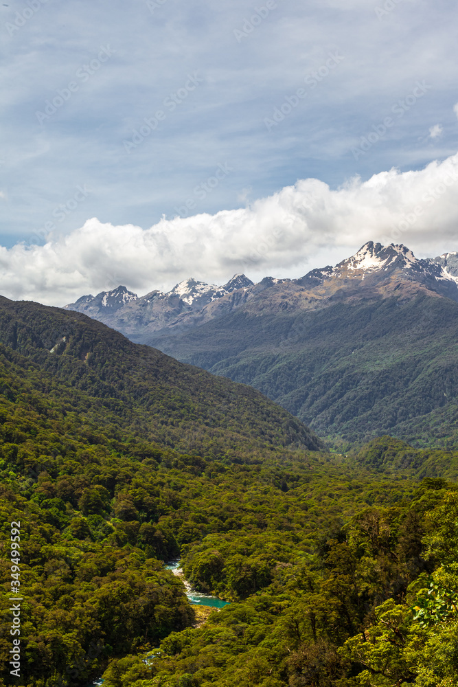 View of the mountains, dense forest and the river below. Landscapes of Fiordland National Park. South Island, New Zealand