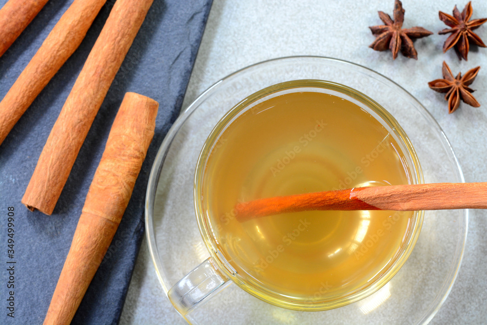 Fototapeta premium Hot cinnamon water with honey in a glass cup