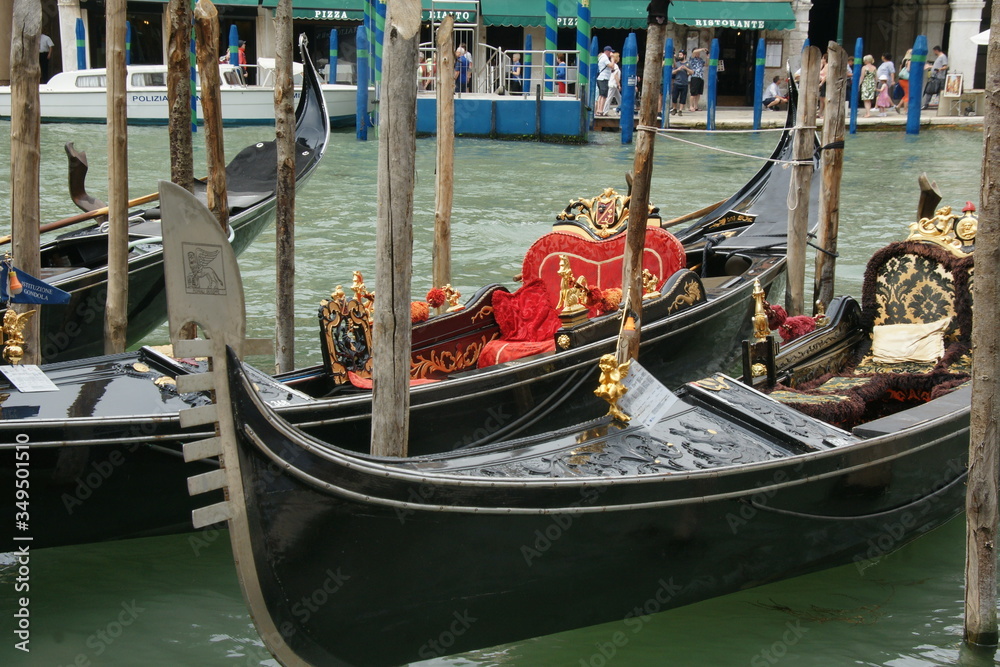 Photo of gondolas  in Venice with green water of Grand canal in summer.