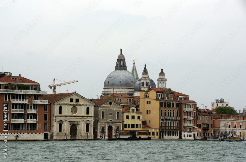 Cityscape with Santa Maria della Salute church with historical facades and adriatic sea in Venice. View from the adriatic sea