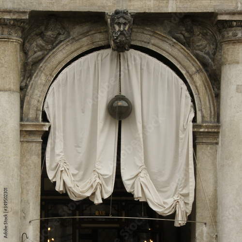 Part of facade of Procuratie nuove with draperies on San Marco square in Venice.