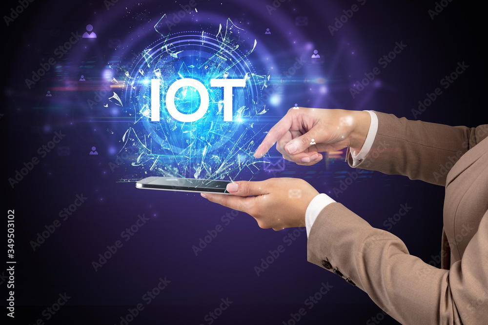 Close-up of a touchscreen with IOT abbreviation, modern technology concept Close-up of a touchscreen with IOT abbreviation, modern technology concept