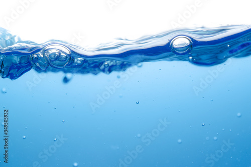 Small bubbles above the water surface, clean blue, refreshing movement, white background, macro
