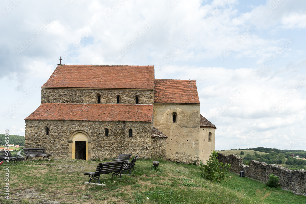 Cisnadioara,  Transylvania,  Romania. Fortified medieval church on top of rock hill in Cisnadioara near Sibiu,  Transylvania,  Romania. Cloudy summer day.