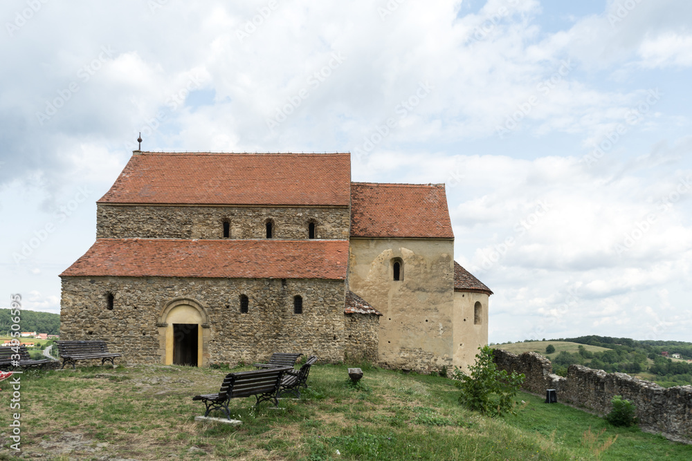 Cisnadioara,  Transylvania,  Romania. Fortified medieval church on top of rock hill in Cisnadioara near Sibiu,  Transylvania,  Romania. Cloudy summer day.