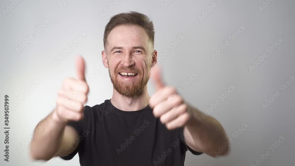 Cheerful guy shoots a medical mask and smiles Cheerful guy shoots a medical mask and smiles