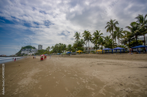 Beautiful view of the beach with sand, and buildings behind in a beautiful day in with sunny weather in a blue sky in Same, Ecuador © Fotos 593