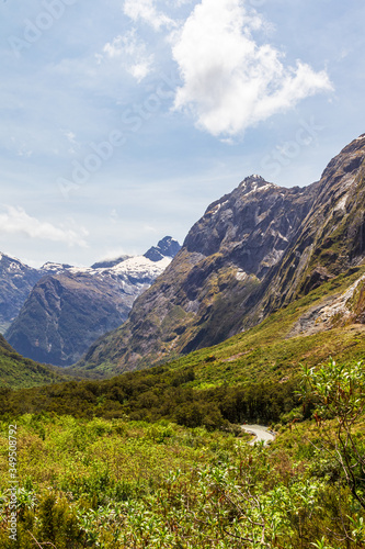 Sheer cliffs in the clouds and a green valley on the way to Fiordland. New Zealand © Victor