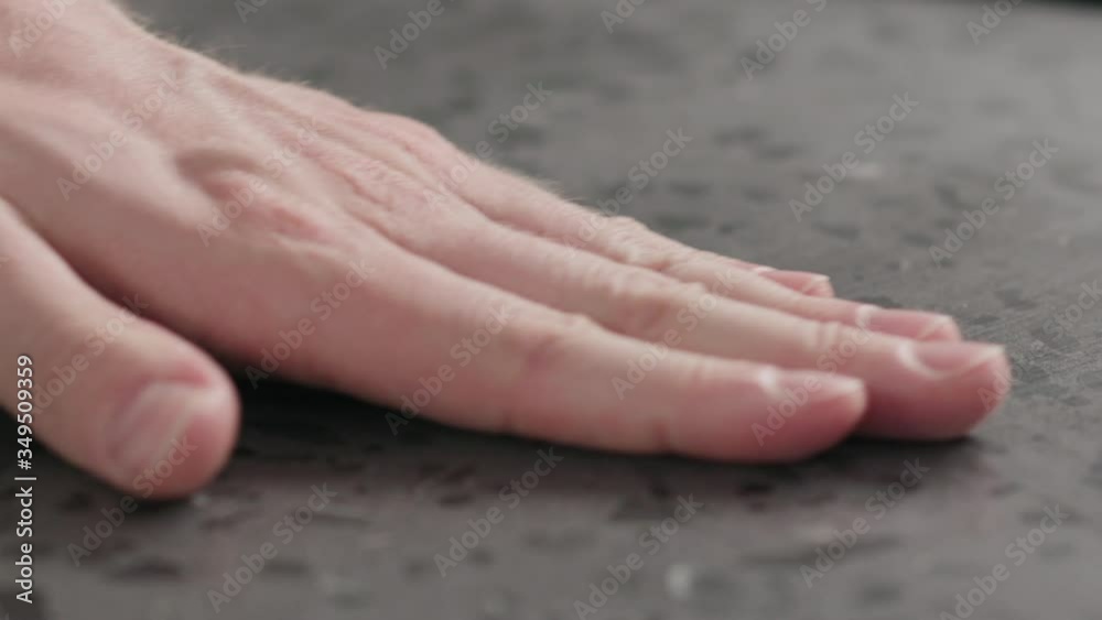 Slow motion man hand check kitchen countertop surface after wet wipe closeup Slow motion man hand check kitchen countertop surface after wet wipe closeup