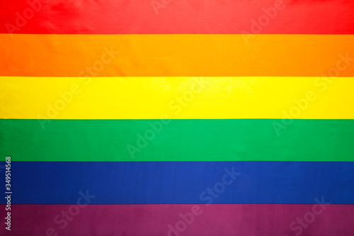 A rainbow flag background with copy space.