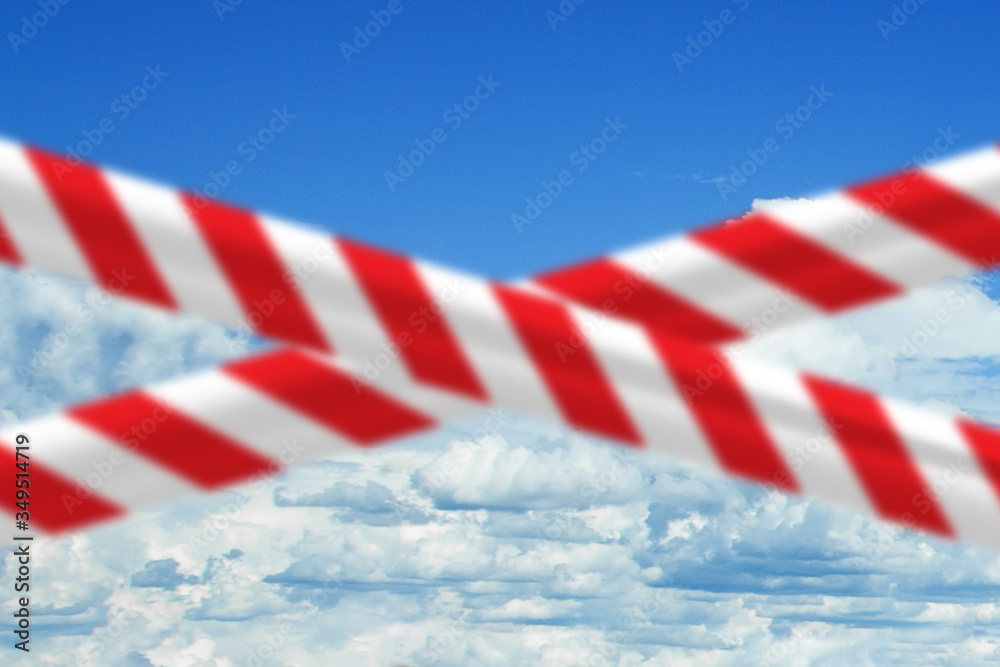 Blue sky with red warning tape. Prohibition and quarantine concept Blue sky with red warning tape. Prohibition and quarantine concept