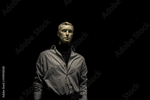 mannequin man in shirt isolated on black background