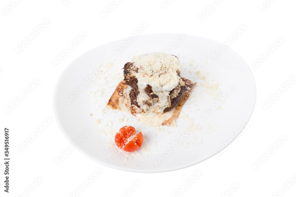 Meat medallion in white sauce on pita bread. Meat medallion in white sauce on pita bread.