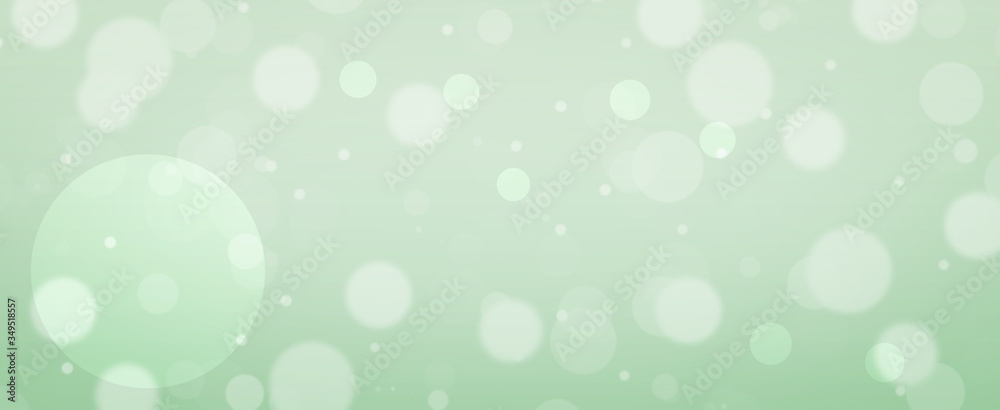Glowing green bokeh background.  Spring concept. Blurred bokeh circles.  Website banner.  Celebration.