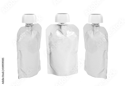 three White empty plastic doy pack with spout and round lid from different angles, for baby food, fruit puree, snack on the go, isolated on a white background photo