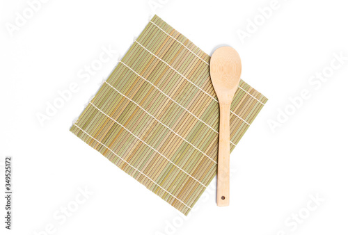 bamboo mat  and wooden ladle isolated on white background.bamboo mat isolated. photo