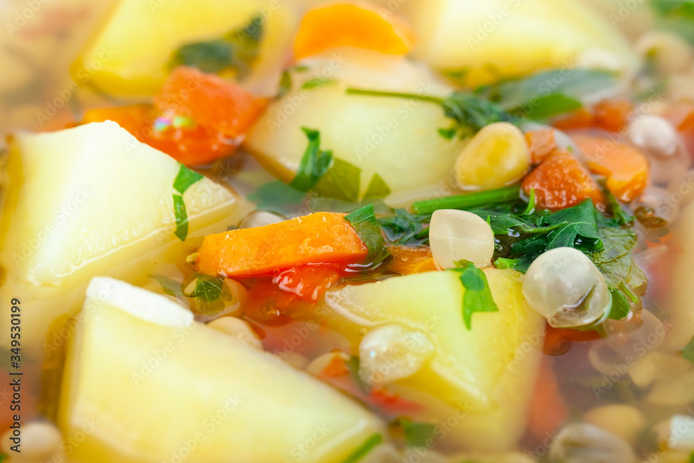 Fresh vegetable soup made of pea, carrot, potato and other vegetables Fresh vegetable soup made of pea, carrot, potato and other vegetables