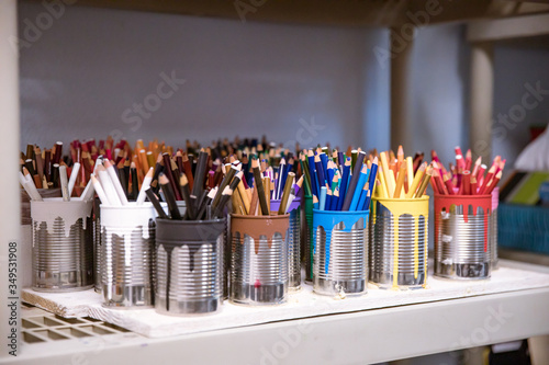 Colorful display of art pencils on a shelf in a school art classroom keep supplies organized