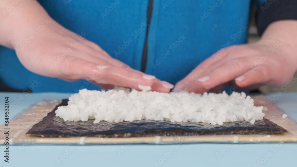 A female chef prepares a traditional Asian dish. Cooking rolls in the home kitchen. A female chef prepares a traditional Asian dish. Cooking rolls in the home kitchen.