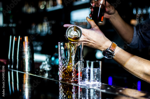 bartender pouring alcohol in a bar © Martin