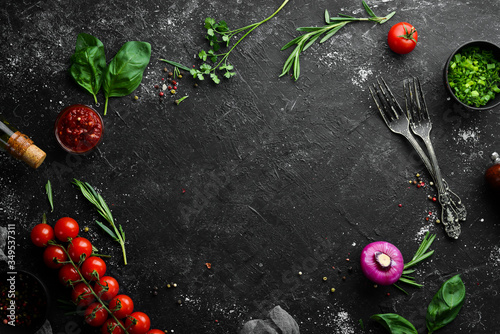 Food background. Vegetables, spices and kitchen utensils on the old table. Free copy space.