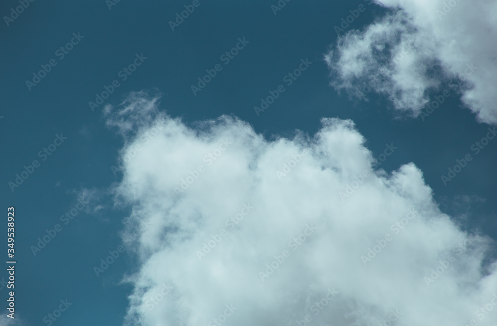 Fluffy clouds cover the summer blue sky Fluffy clouds cover the summer blue sky