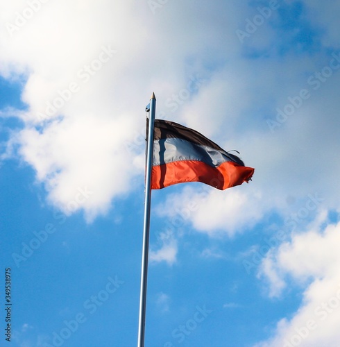 DNR flag on a background of blue sky. A disheveled flag. photo