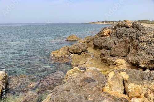 Rocks in the sea in full May on the coast of Taranto, Puglia, Italy