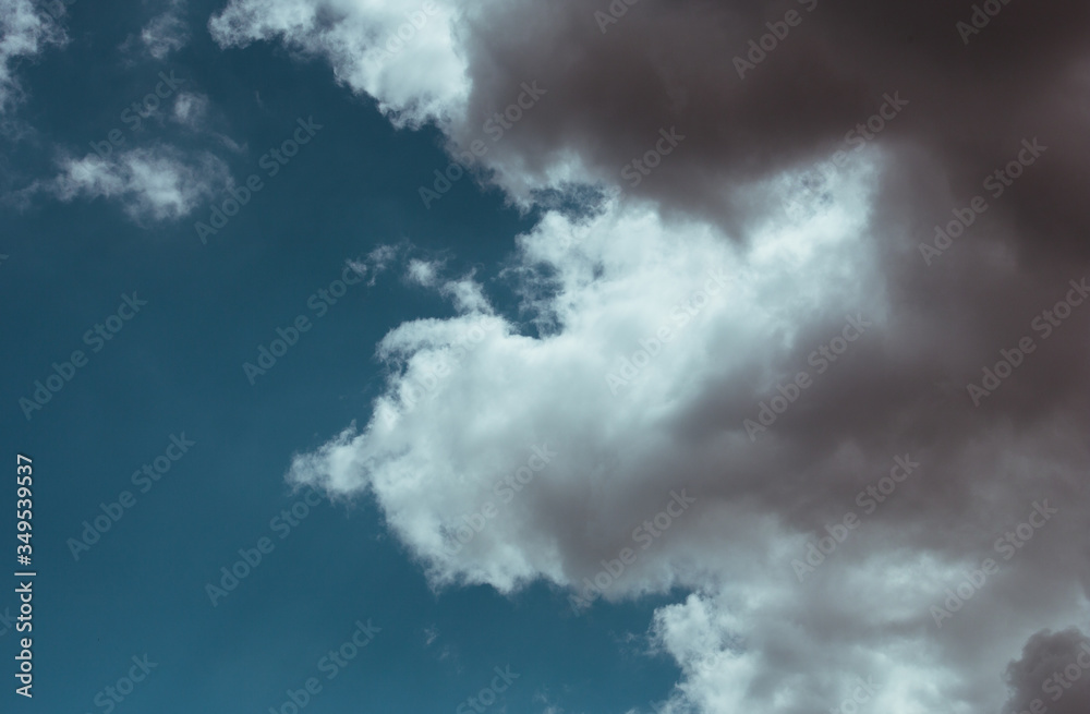 Fluffy clouds cover the summer blue sky Fluffy clouds cover the summer blue sky