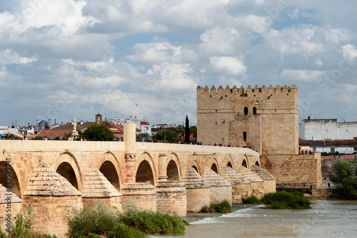 a guadalquivir view of cordoba.
view of the roman bridge and the calahorra tower over the guadalquivir in cordoba. andalusia, spain photo