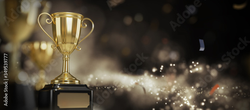 Golden trophy award on dark background. 
Gold winners trophy with copy space for text. 
3d rendering. photo