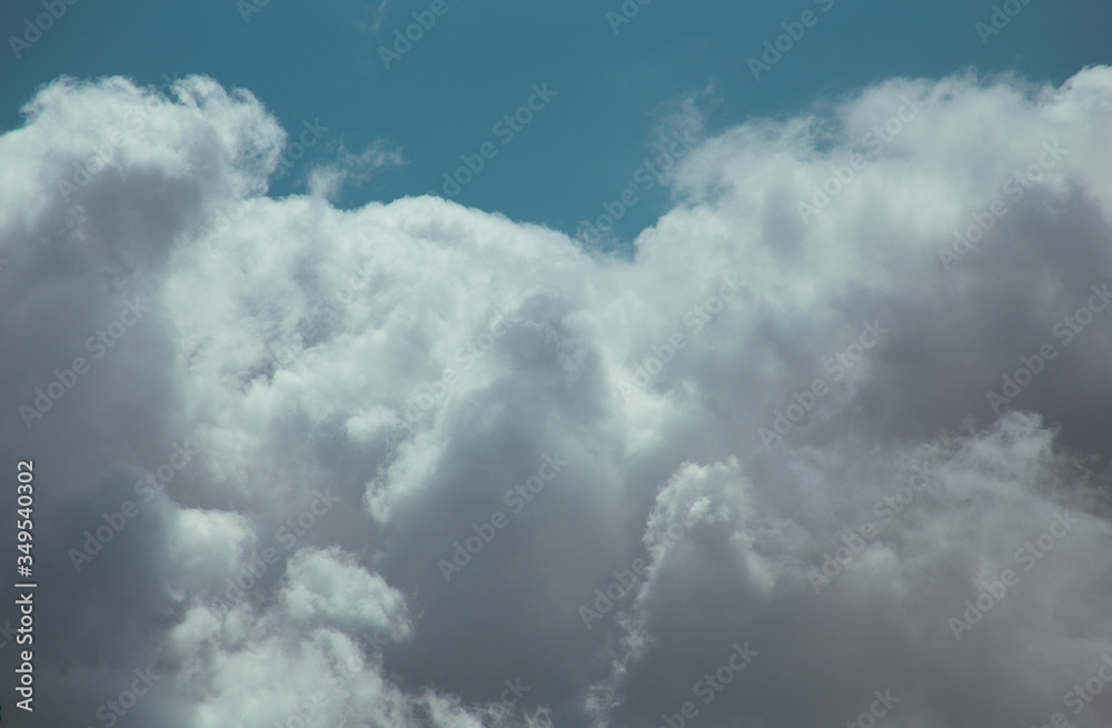 Fluffy clouds cover the summer blue sky Fluffy clouds cover the summer blue sky