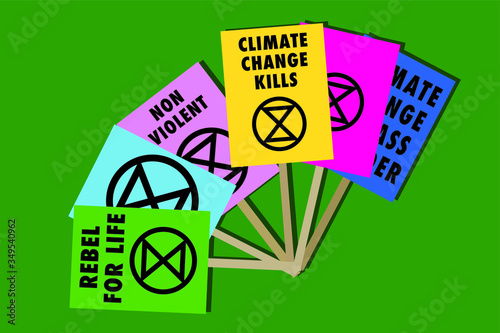 Extinction rebellion climate change placards on a green background
