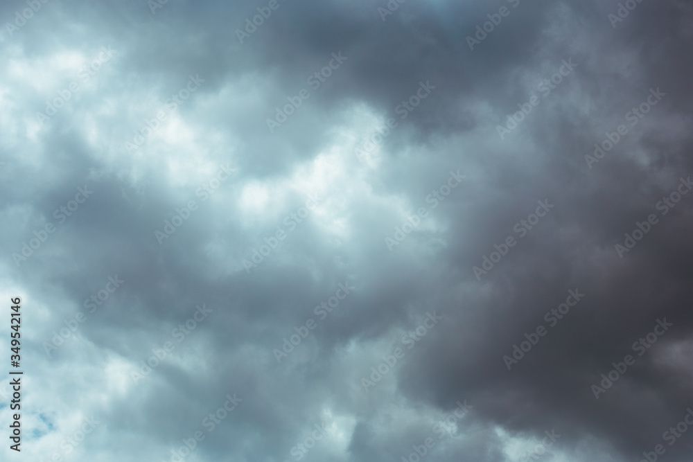 Fluffy clouds cover the summer blue sky