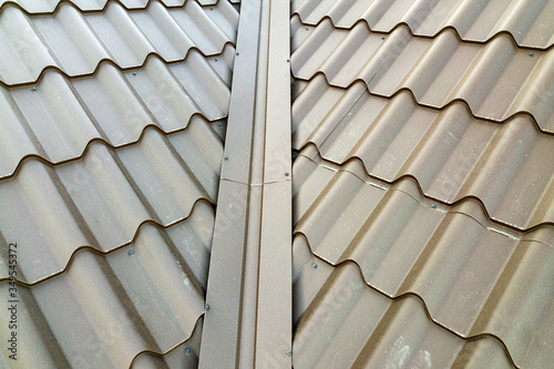 Close up of new house roof structure covered with metal tile sheets. photo