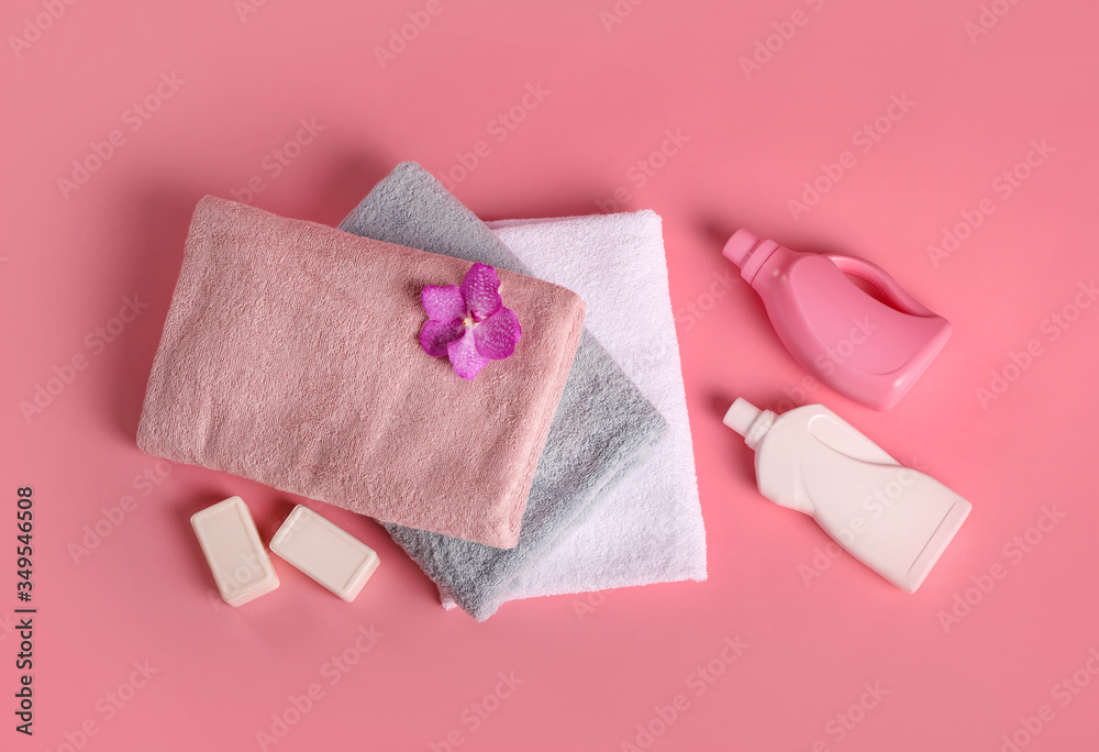 Bath towels, detergents, soap and orchid flower on pink bachground Bath towels, detergents, soap and orchid flower on pink bachground