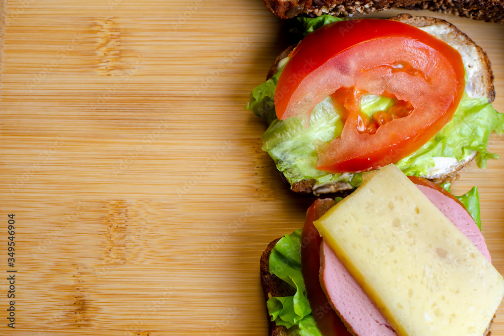 fresh sandwiches on a light wooden background fresh sandwiches on a light wooden background