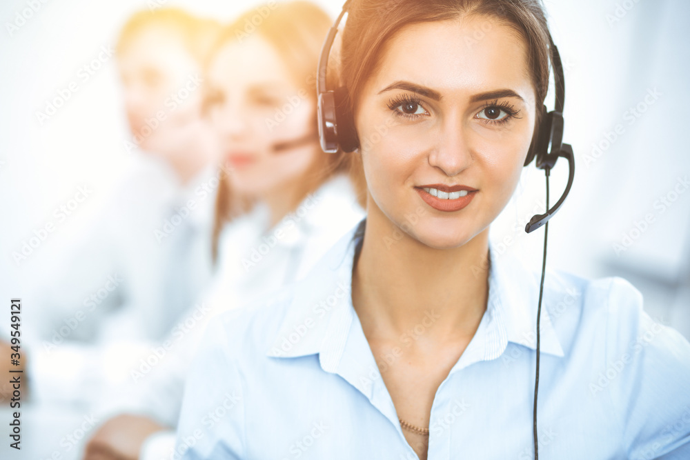 Call center. Focus on beautiful business woman in headset Call center. Focus on beautiful business woman in headset
