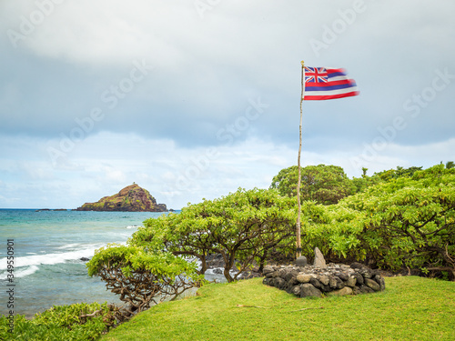 Koki Beach Park Maui. The dark red sand at Koki Beach was produced by the nearby cinder cone hill of Ka Iwi O Pele. Koki Beach is one of two famous Hana surf breaks and favorite spot for local surfers photo